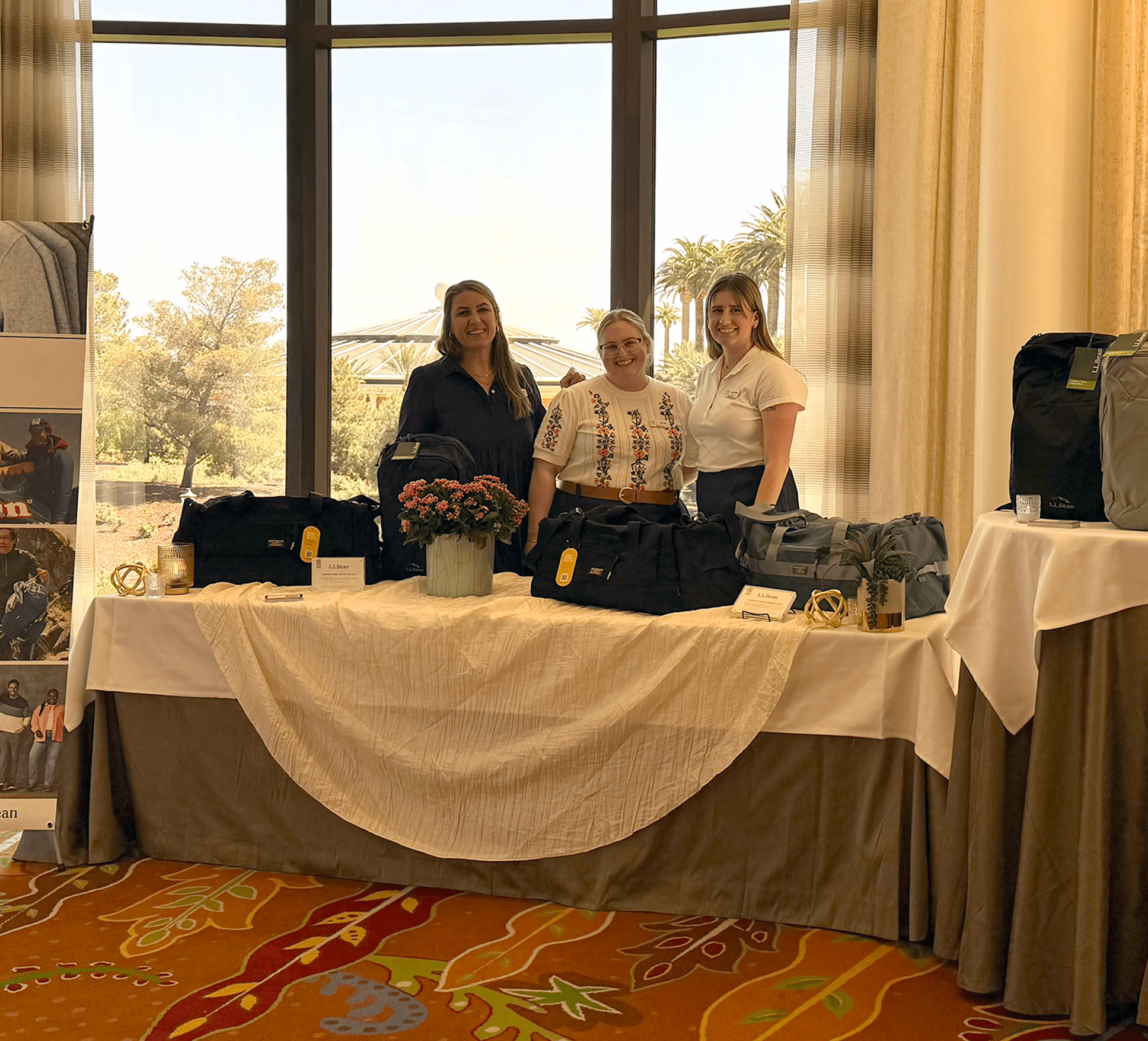 Three Global Evento Employees stand behind their gifting set up at a corporate event in Las Vegas, NV.