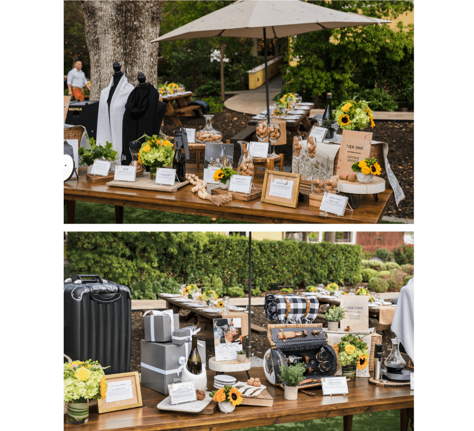 A table full of gift options themed to match Napa Valley, California. Gift options included picnic baskets, scarves, wine accessories and suitcases.